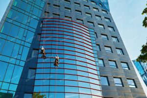 Workers cleaning windows in business center in scyscraper Stock Photo, ft. action & Blue - Envato